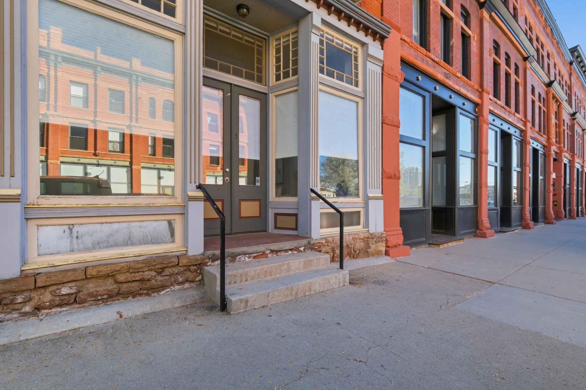Brick storefront and tall transom windows along Zuni Street