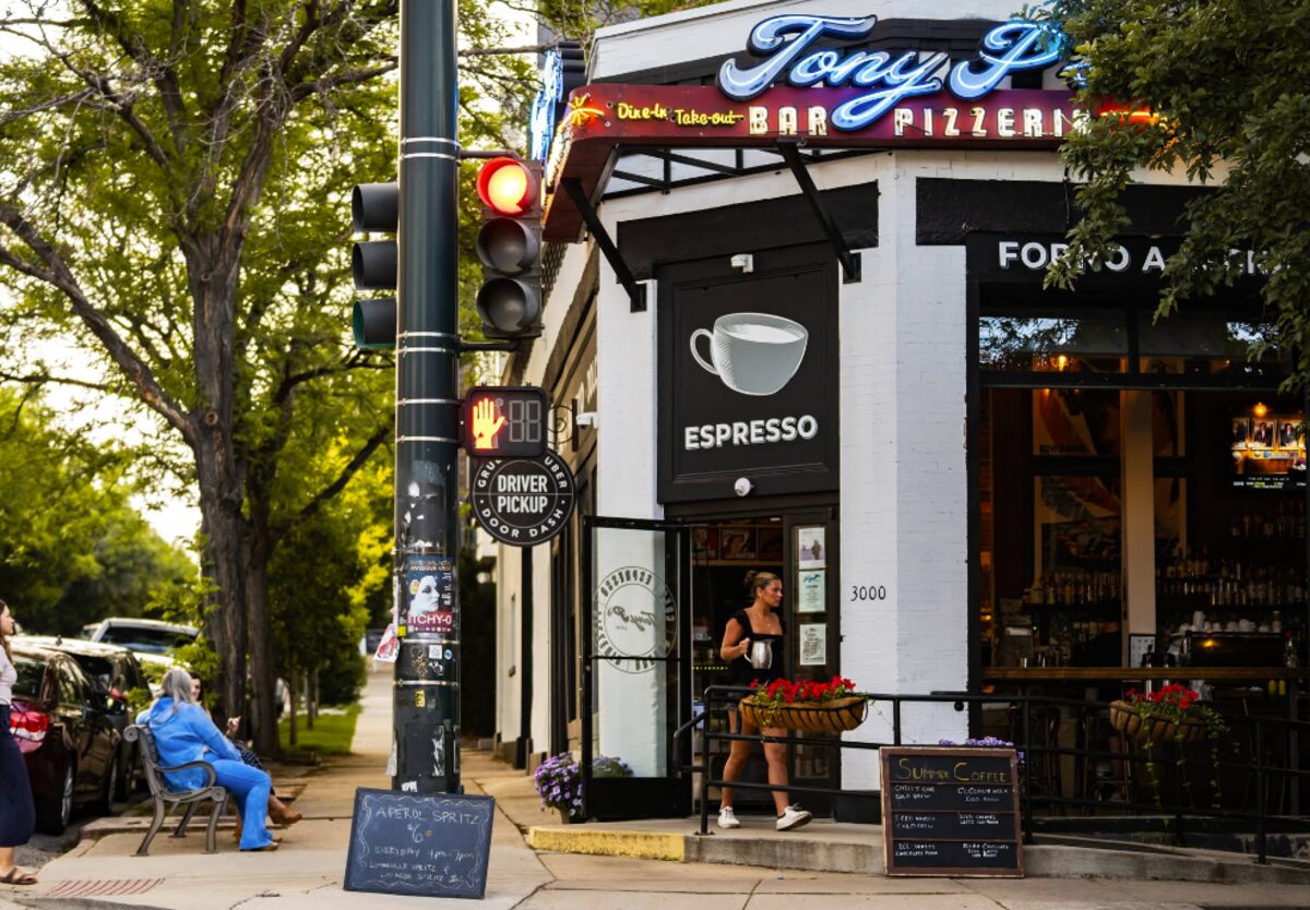 Corner bar and pizzeria with neon signage and sidewalk seating in LoHi Denver
