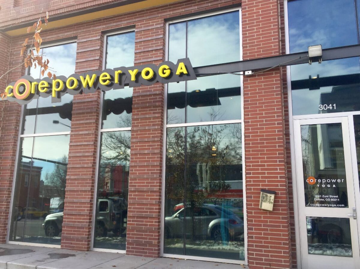 Red brick storefront with tall windows housing CorePower Yoga on Zuni Street in LoHi Denver