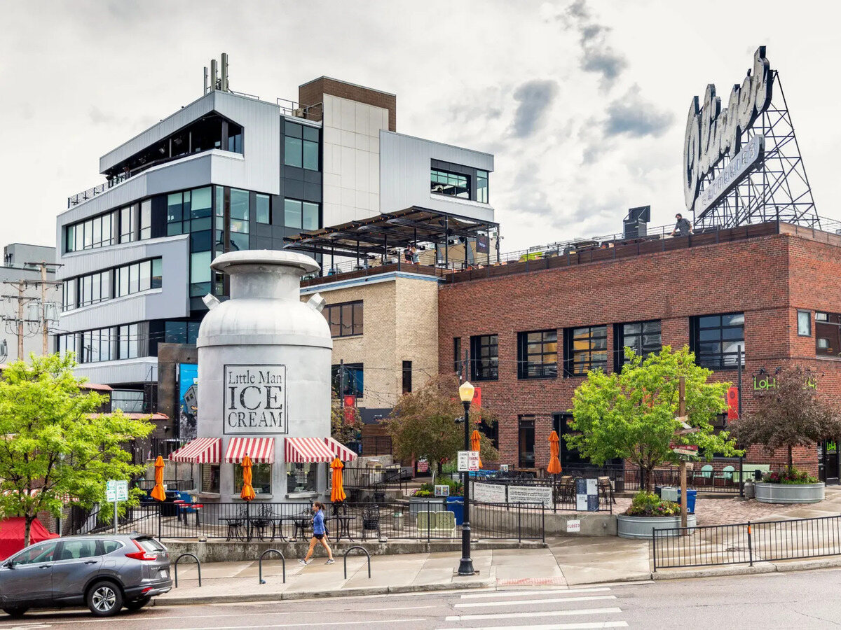 Little Man Ice Cream's giant milk can with striped awnings and brick buildings behind it in LoHi Denver